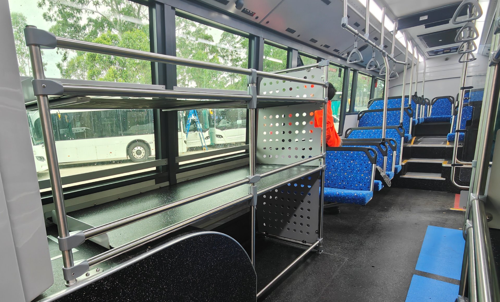 photo of the bus interior, showing a large luggage rack on the right-hand side